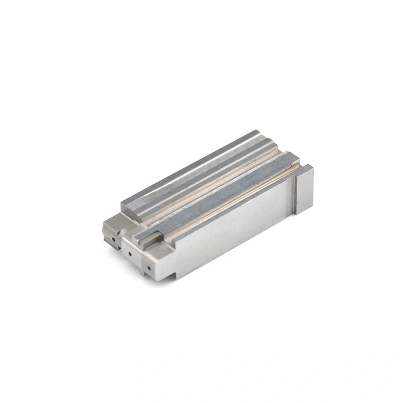 Elongated rectangular machined metal part with parallel grooves and small end holes